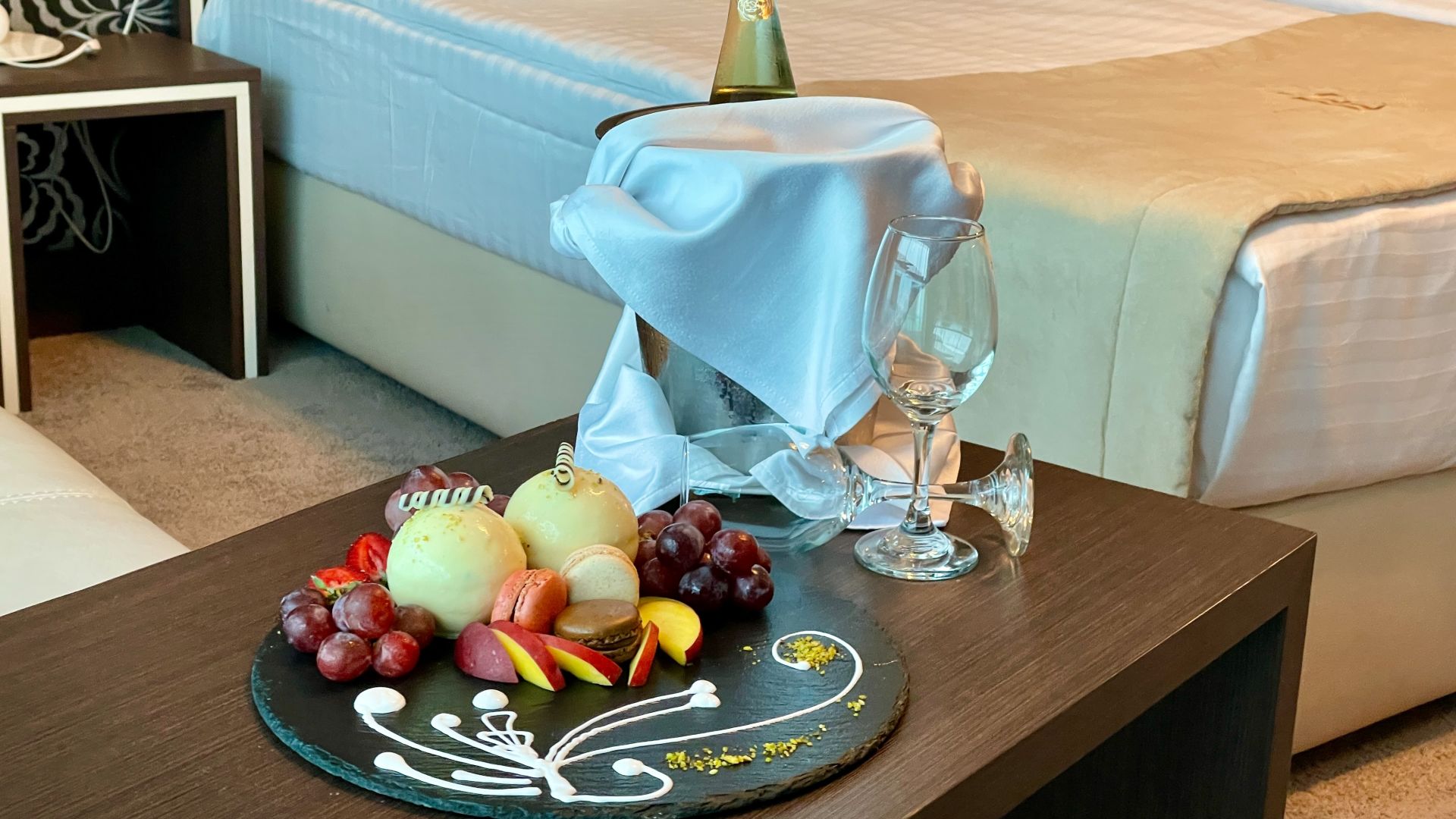 A Table With A Plate Of Fruit And A Bottle Of Wine