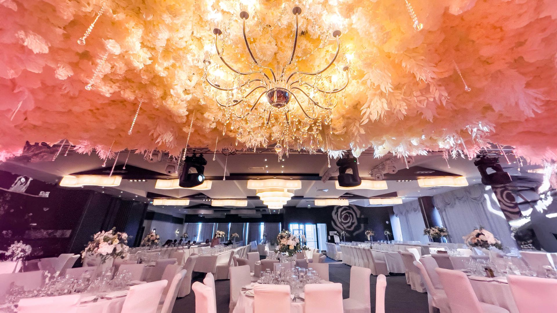 A Stage With A Large Chandelier And Chairs